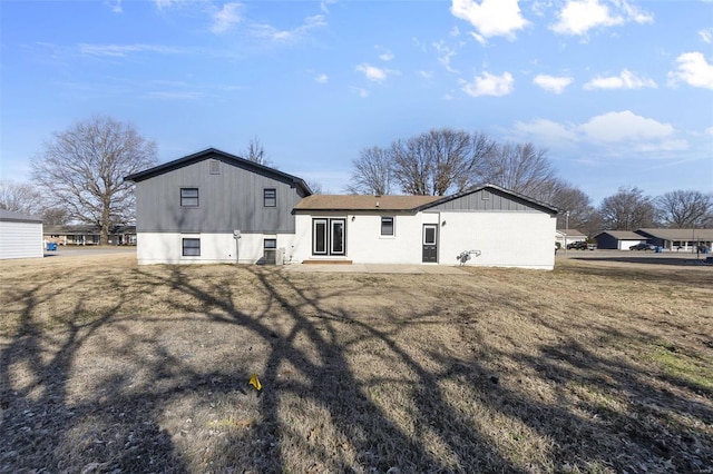 back of property with a lawn