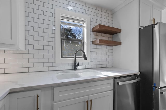 kitchen featuring decorative backsplash, white cabinets, appliances with stainless steel finishes, open shelves, and a sink