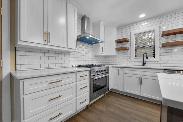 kitchen featuring open shelves, dark wood-type flooring, a sink, wall chimney range hood, and high end stove