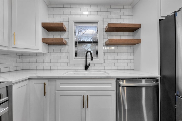 kitchen featuring stainless steel appliances, white cabinetry, open shelves, and a sink