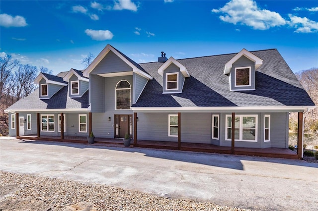 view of front of home with covered porch and roof with shingles