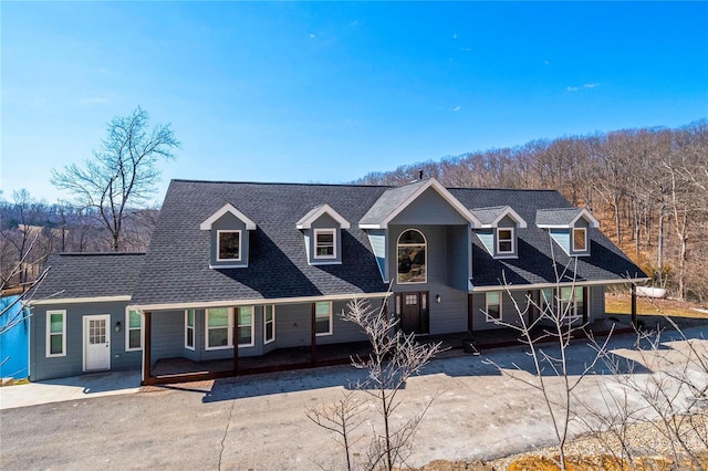 view of front of home with a shingled roof