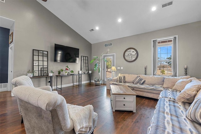 living room with high vaulted ceiling, dark wood finished floors, and visible vents