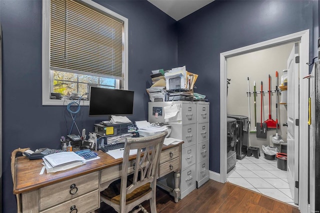 home office featuring baseboards, washer and clothes dryer, and wood finished floors