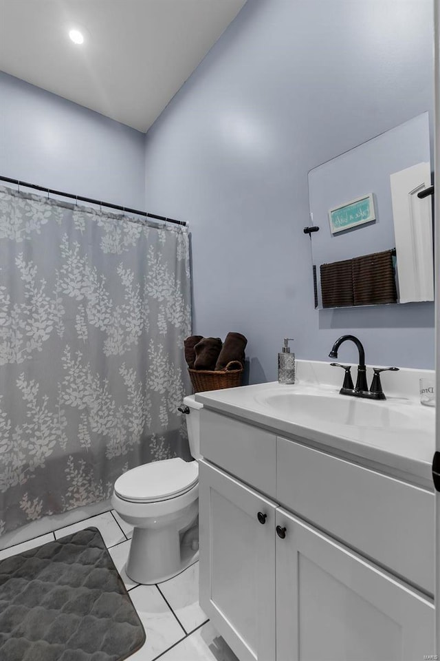 bathroom with curtained shower, vanity, and toilet