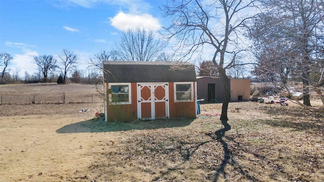 view of shed featuring fence