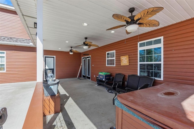 view of patio featuring a ceiling fan and a hot tub