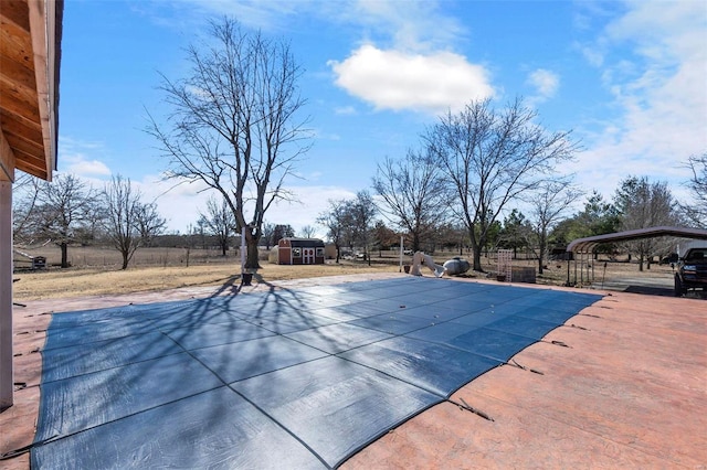 view of pool featuring fence, a fenced in pool, and an outbuilding