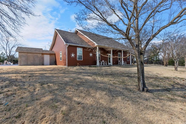 view of side of home with a porch and a lawn