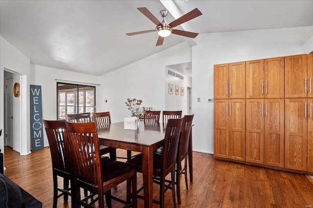 dining area featuring lofted ceiling, visible vents, dark wood-type flooring, and ceiling fan