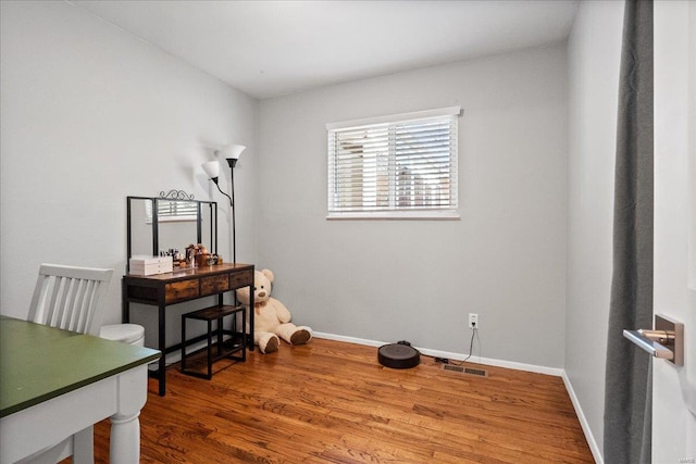 office with visible vents, baseboards, and wood finished floors