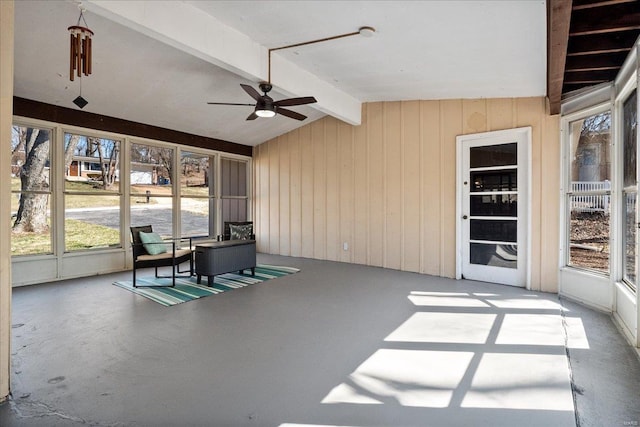 sunroom featuring lofted ceiling with beams and ceiling fan