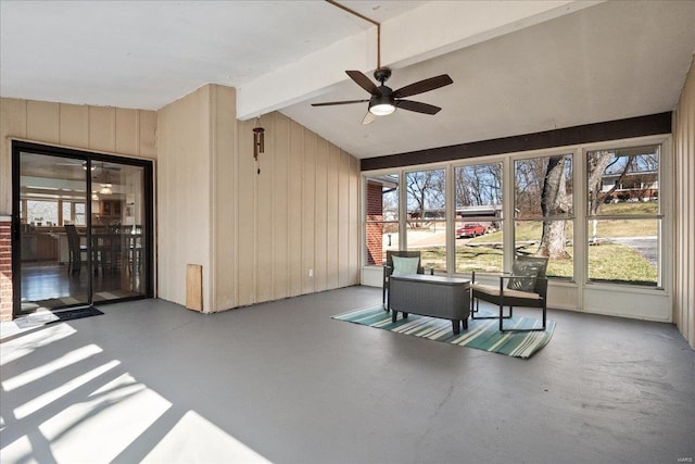 sunroom / solarium with lofted ceiling with beams and a ceiling fan