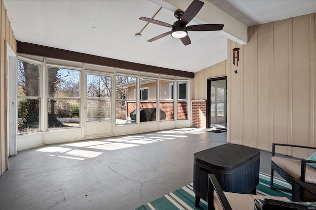 unfurnished sunroom featuring lofted ceiling with beams and a ceiling fan