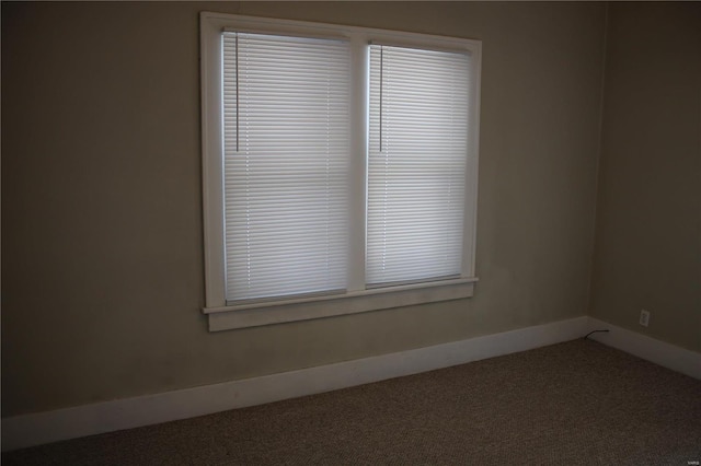 spare room with carpet and baseboards