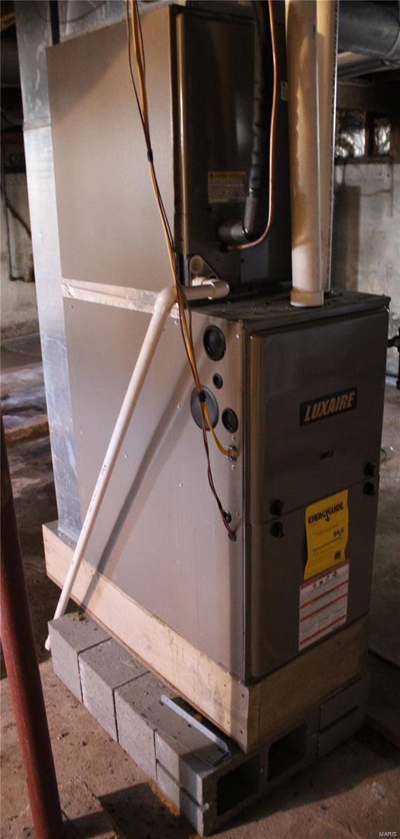 utility room with heating unit