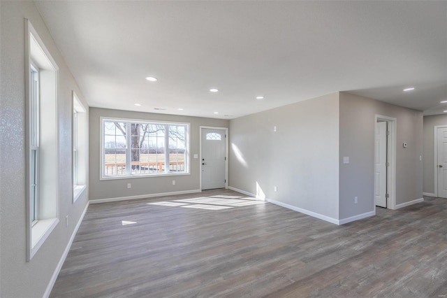 interior space with recessed lighting, wood finished floors, and baseboards