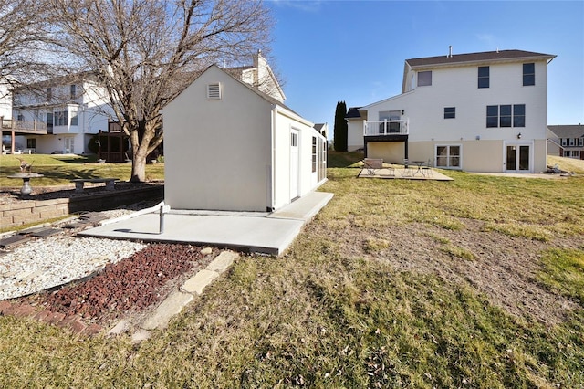 rear view of house featuring a yard and a patio area