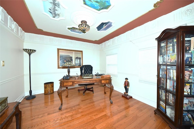 home office featuring baseboards and wood finished floors