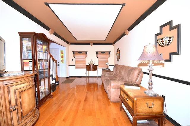 living area with stairway and light wood-style floors