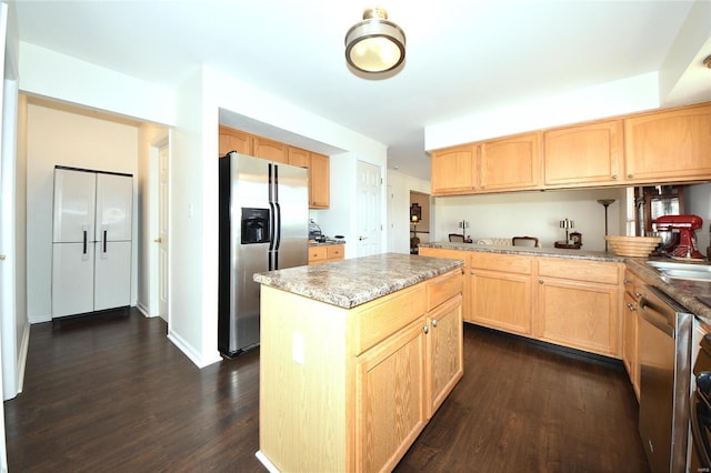 kitchen featuring light brown cabinetry, appliances with stainless steel finishes, dark wood-style flooring, and a kitchen island