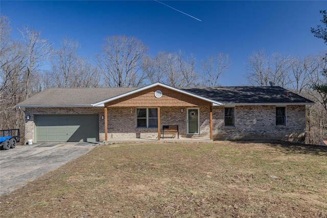 ranch-style house with a garage, a front yard, brick siding, and driveway