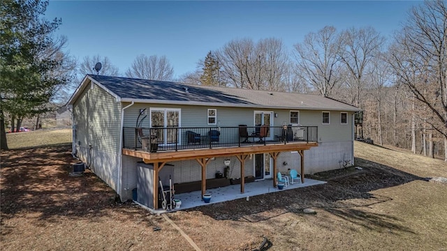 rear view of property featuring a deck and a patio