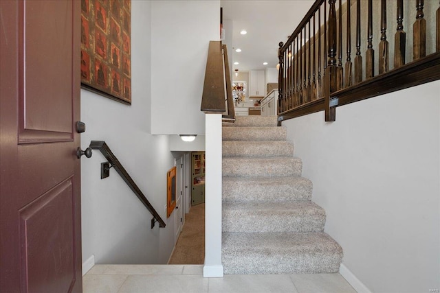 staircase with recessed lighting, tile patterned flooring, and baseboards