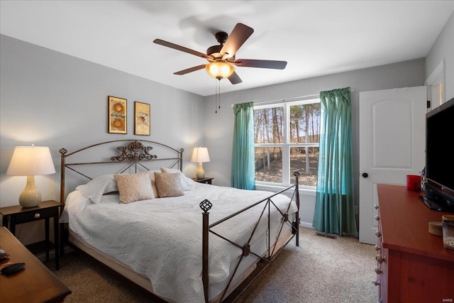 carpeted bedroom featuring ceiling fan and visible vents