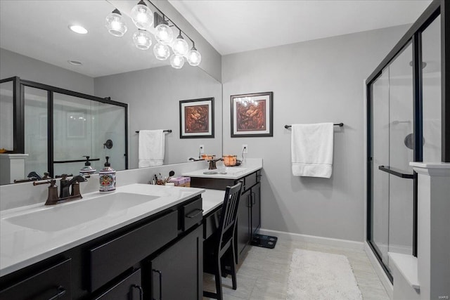 bathroom featuring a stall shower, baseboards, and vanity