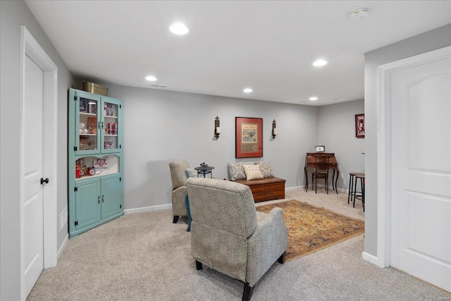 sitting room with light carpet, baseboards, visible vents, and recessed lighting