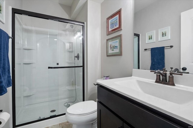 bathroom featuring toilet, a stall shower, and vanity