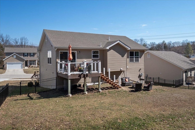 rear view of property featuring roof with shingles, a yard, stairs, fence, and a wooden deck