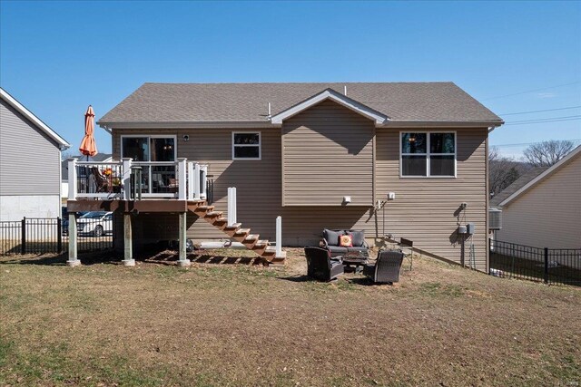 back of property featuring a shingled roof, a lawn, fence, a wooden deck, and stairs