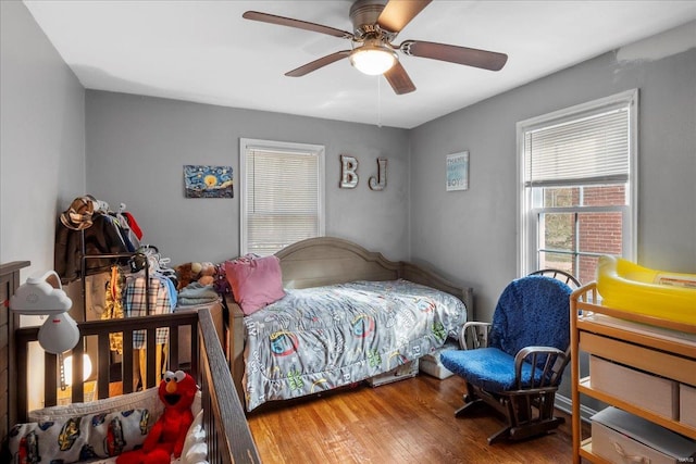 bedroom with a ceiling fan and hardwood / wood-style floors