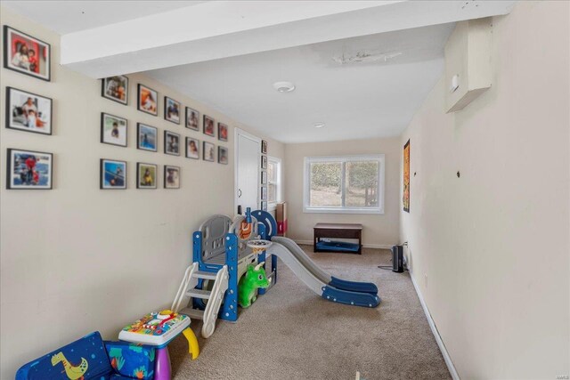 rec room featuring carpet floors and baseboards