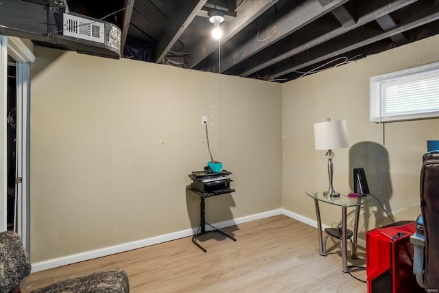 interior space featuring baseboards and wood finished floors