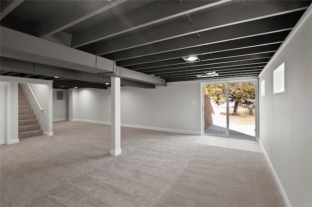 basement with carpet flooring, stairs, and baseboards