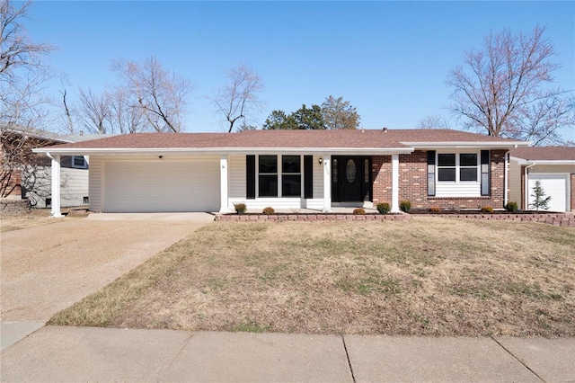 ranch-style home featuring brick siding, an attached garage, concrete driveway, and a front lawn