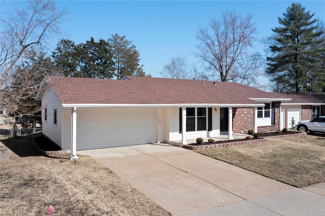 ranch-style house with a garage, roof with shingles, concrete driveway, and a front lawn