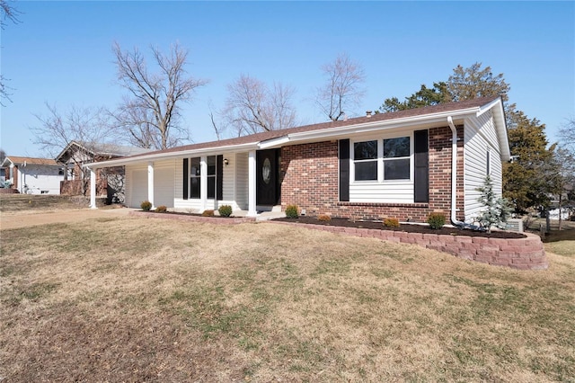 ranch-style home with a garage, brick siding, and a front yard