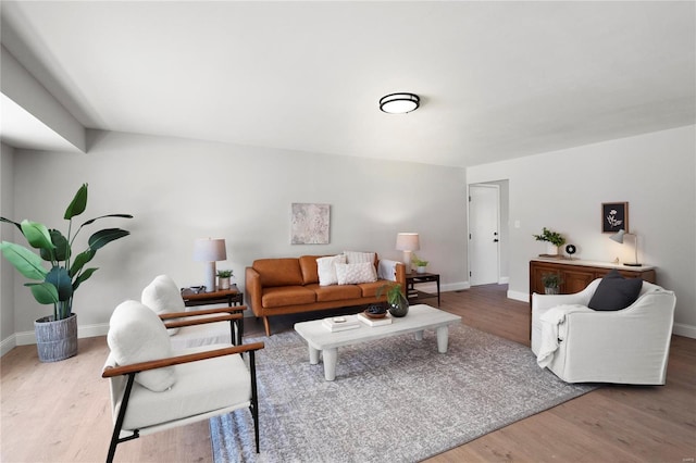 living room featuring baseboards and wood finished floors