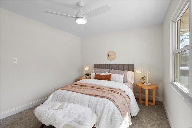 carpeted bedroom featuring a ceiling fan and baseboards