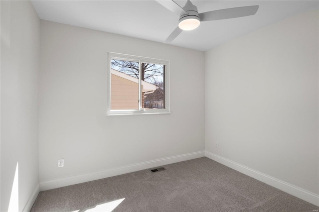 unfurnished room with visible vents, carpet floors, baseboards, and a ceiling fan