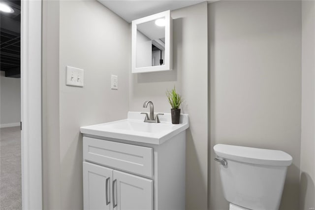 half bathroom with vanity and toilet