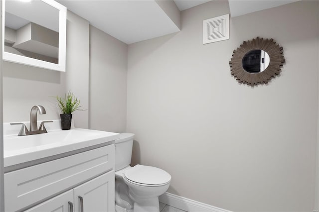 bathroom with vanity, baseboards, visible vents, tile patterned floors, and toilet