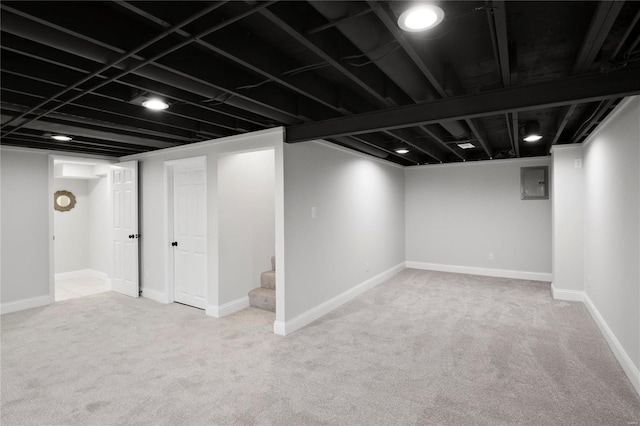 finished basement with electric panel, baseboards, carpet floors, and stairs