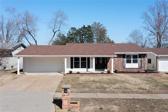 ranch-style home featuring brick siding, a shingled roof, concrete driveway, a front yard, and an attached garage