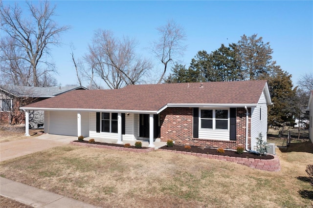 ranch-style home with a front yard, driveway, an attached garage, covered porch, and brick siding