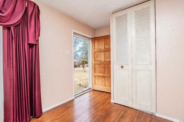 entrance foyer featuring baseboards and wood finished floors